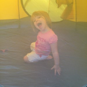 Little One hams it up in the tent.